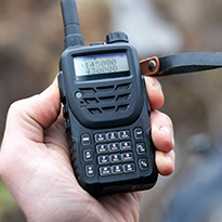 a hand holding a walkie talkie